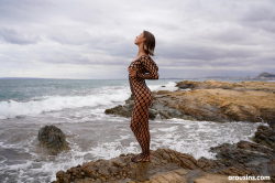 Avery-poses-nude-on-rocky-coast