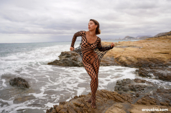 Avery-poses-nude-on-rocky-coast