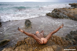 Avery-poses-nude-on-rocky-coast