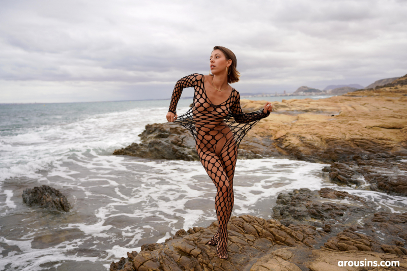 Avery poses nude on rocky coast