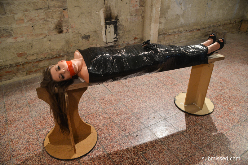 Monalee wrapped in plastic mouthstuffed tapegagged