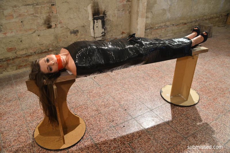Monalee wrapped in plastic mouthstuffed tapegagged